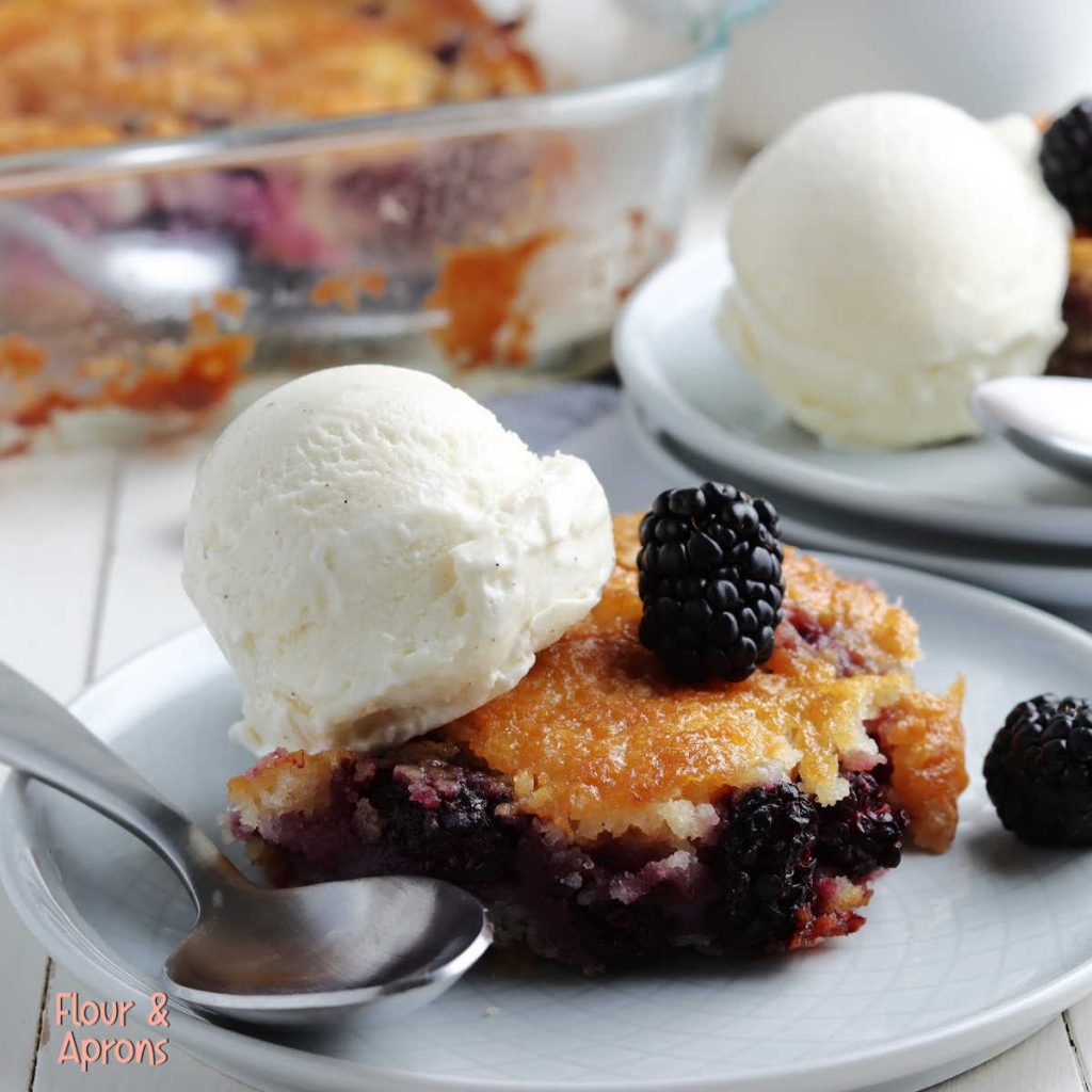 blackberry cobbler on plate with a scoop of ice cream