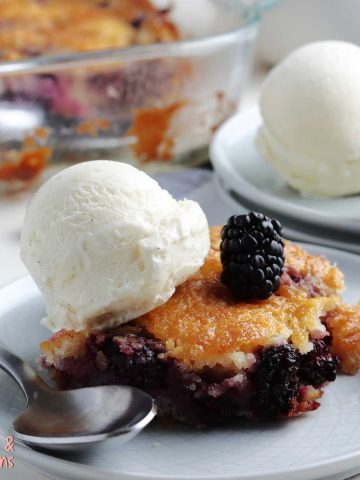 blackberry cobbler on plate with a scoop of ice cream