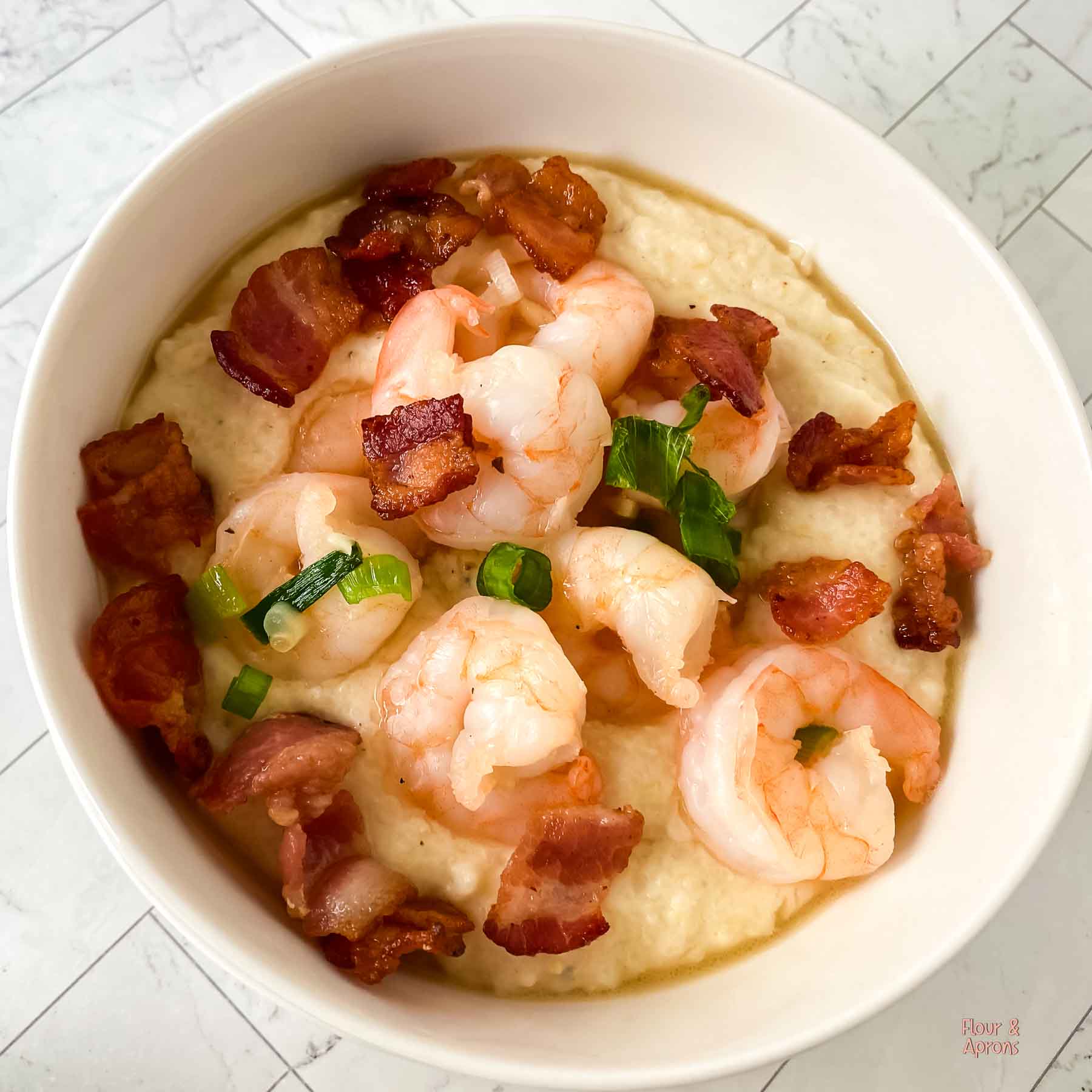 Top down view of a bowl of shrimp and Grits.