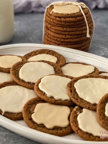 Frosted molasses cookies on a plate.