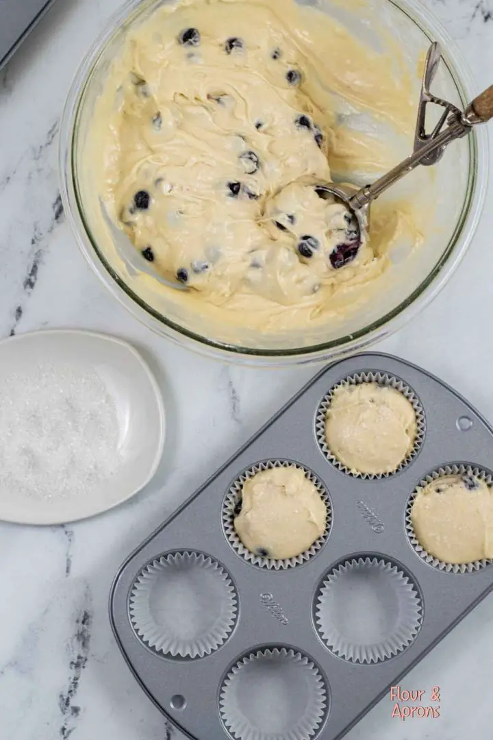 Using a cookie scoop and filling muffin liners.