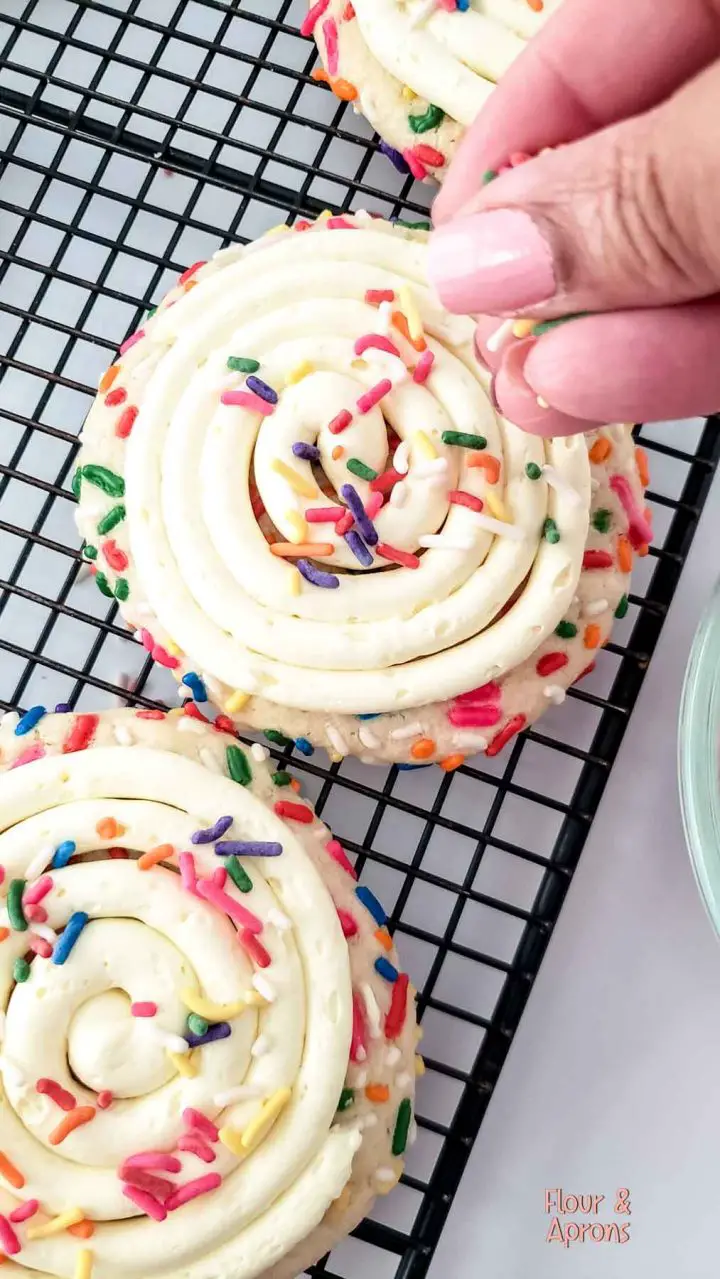 Adding sprinkles to cookie.