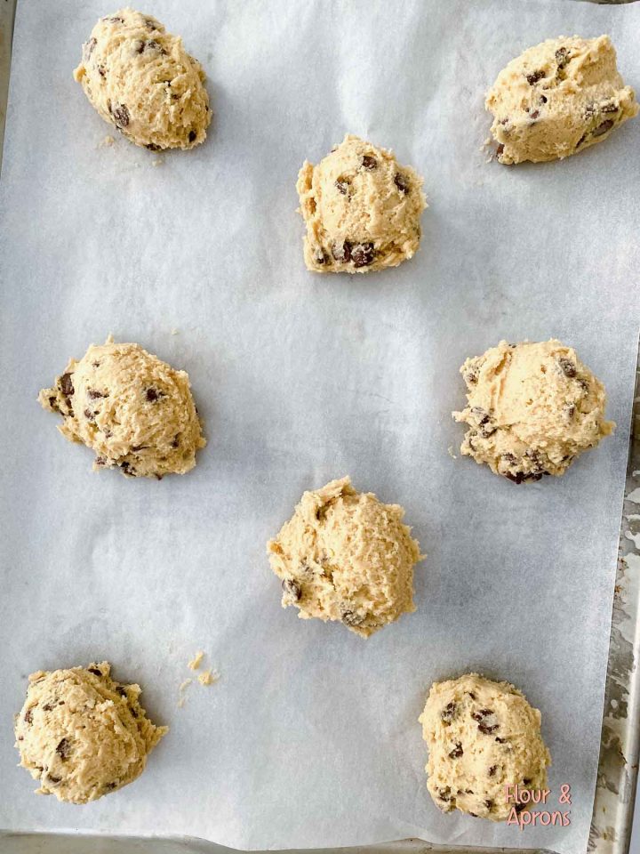 Cookie dough balls on cookie sheet.