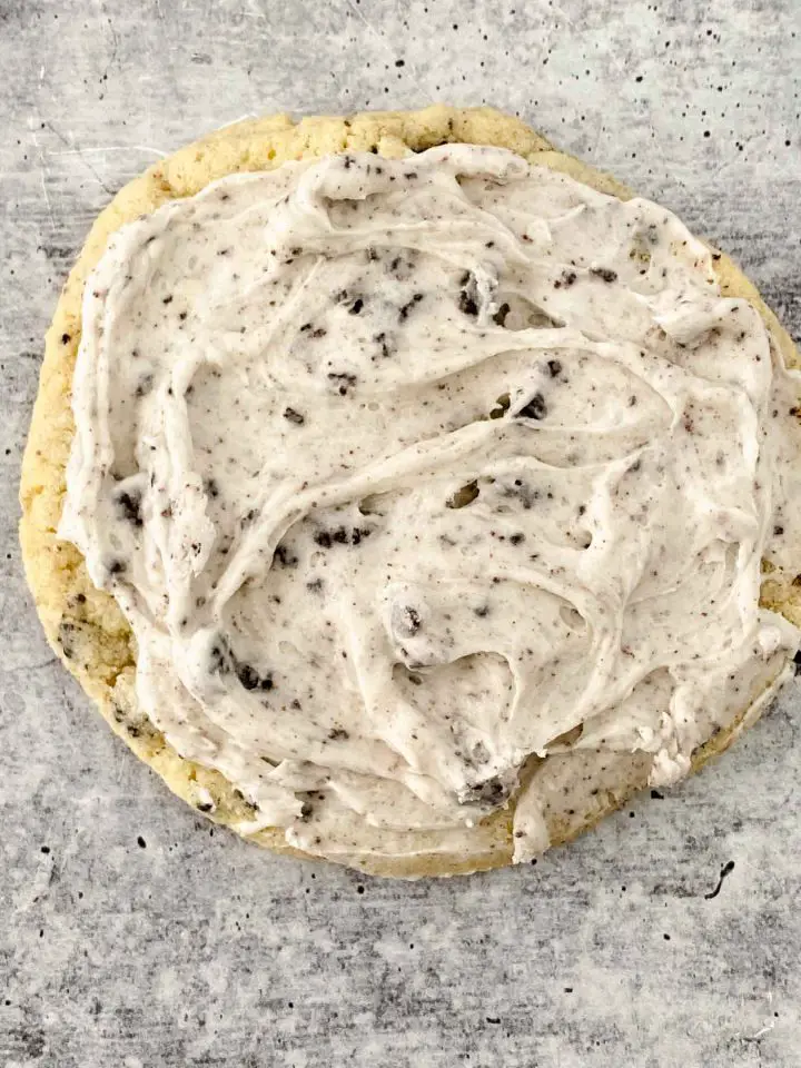 Frosting added to cookie and spread around.