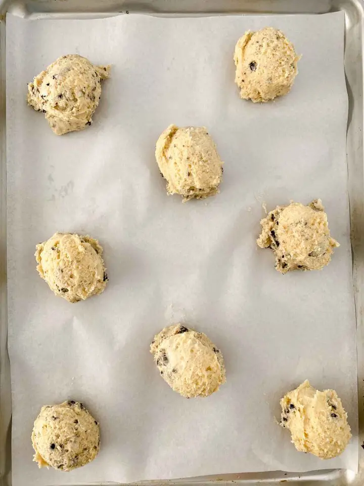 Cookie dough balls on bake sheet.