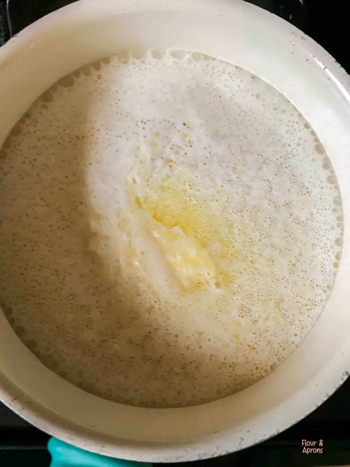 Boiled saucepan with milk and butter.