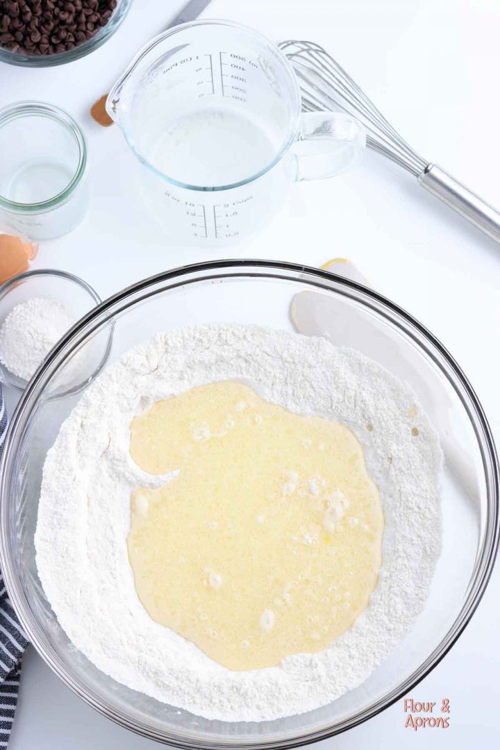 wet ingredients added to flour mix in bowl.
