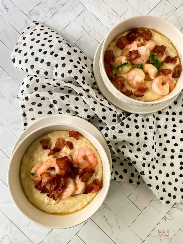 Top down of two bowls filled with shrimp and grits.