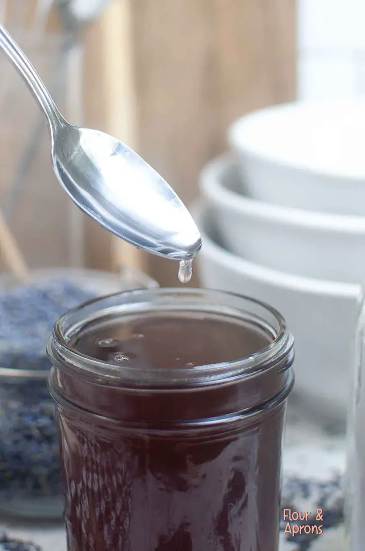 lavender syrup dripping off spoon.