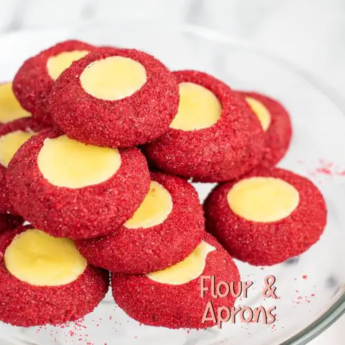 Stack of red velvet thumbprint cookies.